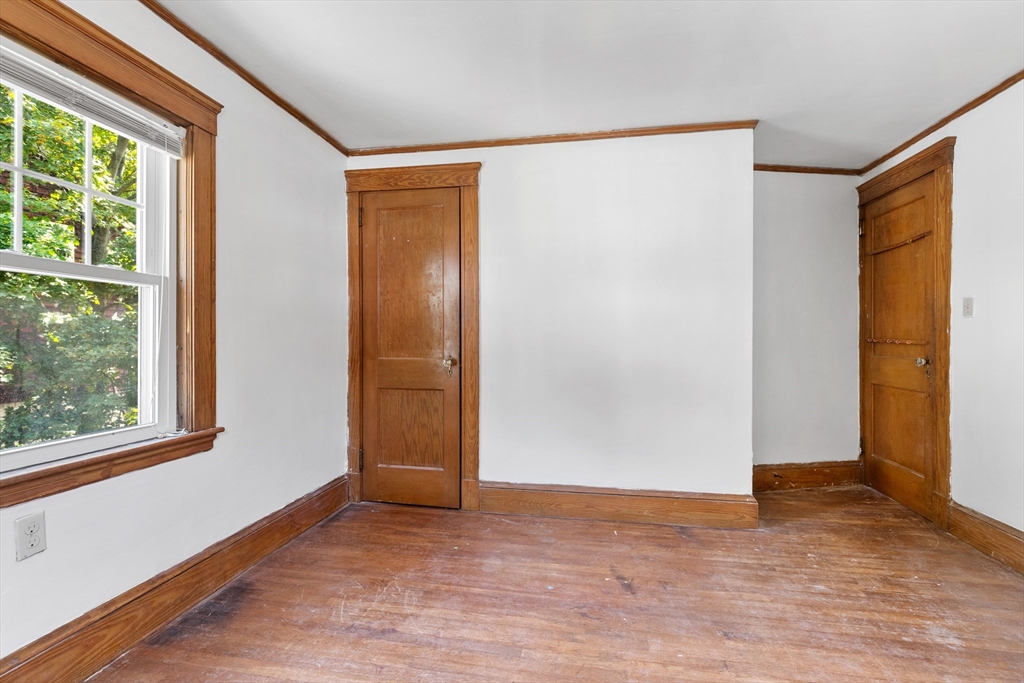 6 Peter Tufts Road Arlington, MA 02474 - Photo 11 of 35 an empty room with wooden floor and windows