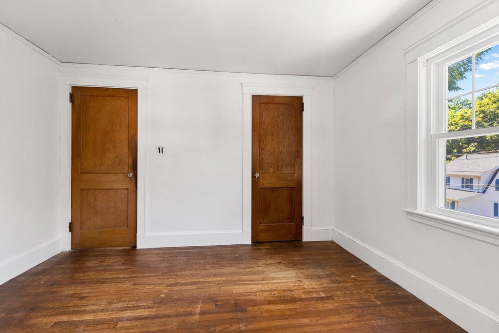 6 Peter Tufts Road Arlington, MA 02474 - Photo 14 of 35 a view of an empty room with window and wooden floor