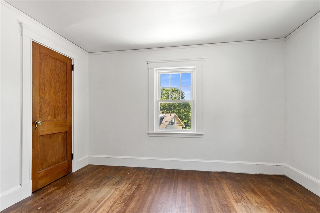 6 Peter Tufts Road Arlington, MA 02474 - Photo 15 of 35 an empty room with wooden floor and a window