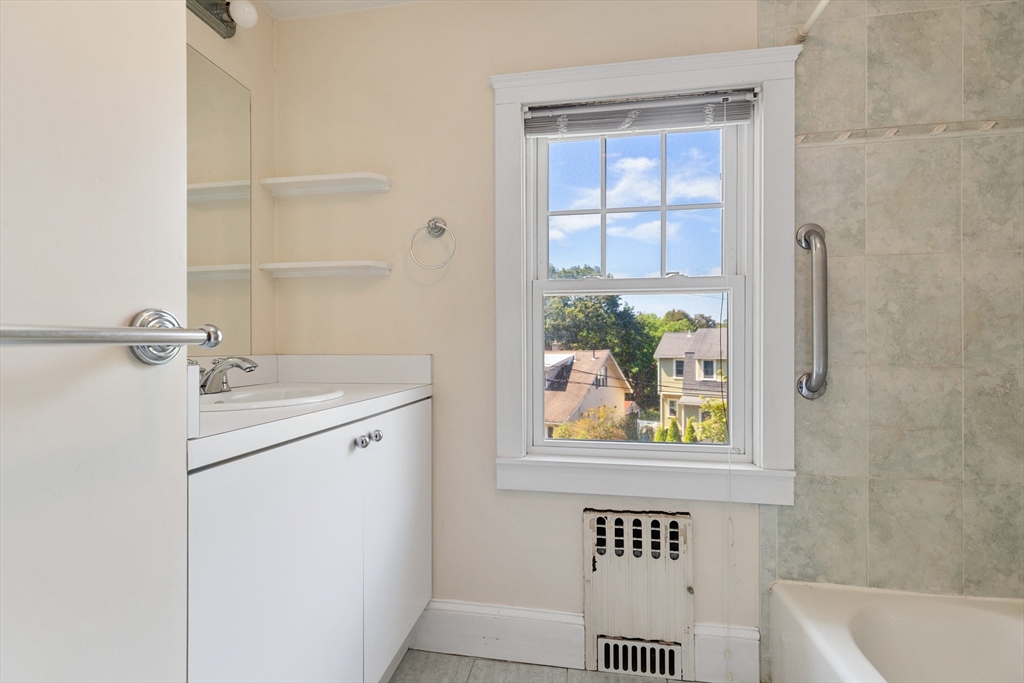 6 Peter Tufts Road Arlington, MA 02474 - Photo 18 of 35 a bathroom with a window sink and mirror