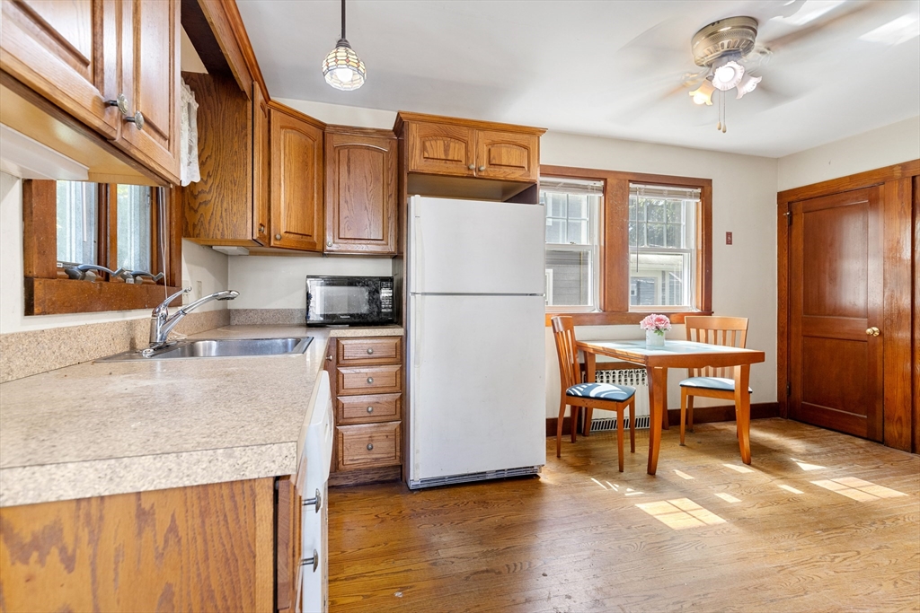 6 Peter Tufts Road Arlington, MA 02474 - Photo 3 of 35 a kitchen with refrigerator cabinets dining table and chairs