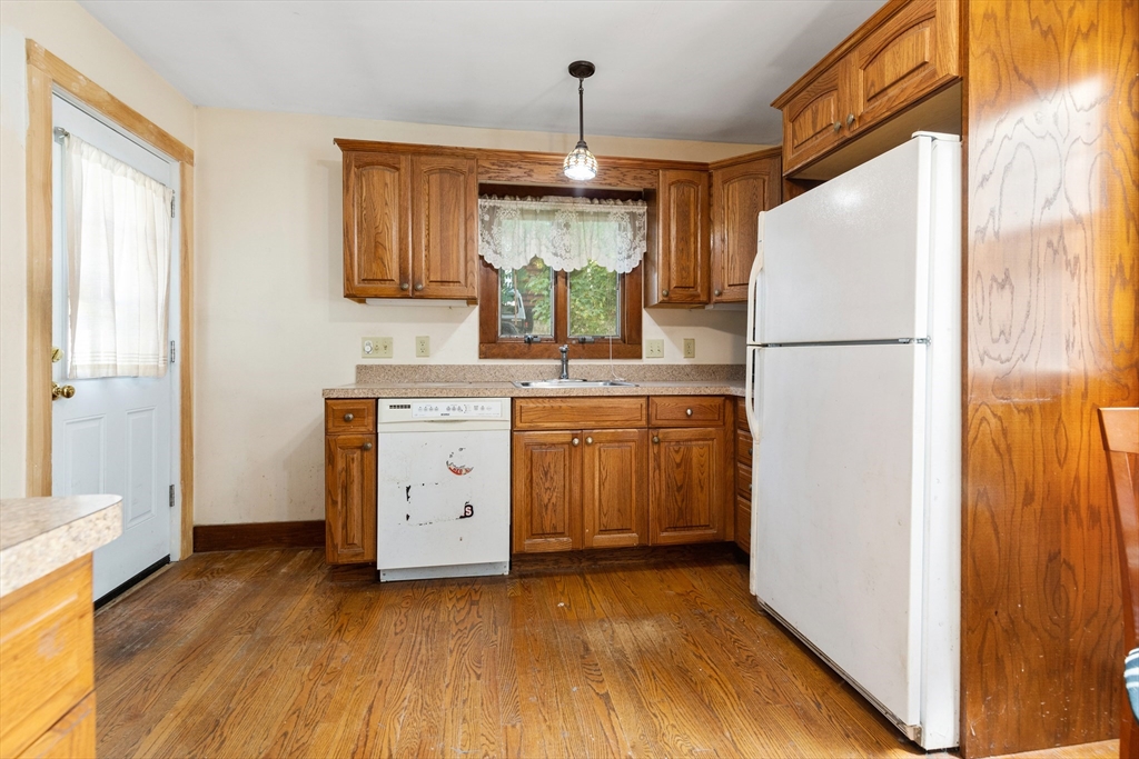 6 Peter Tufts Road Arlington, MA 02474 - Photo 4 of 35 a kitchen with a refrigerator a sink and dishwasher with wooden floor