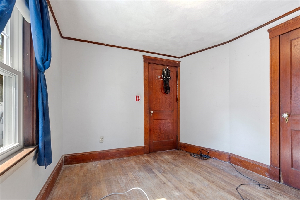 6 Peter Tufts Road Arlington, MA 02474 - Photo 9 of 35 a view of an empty room with window and wooden floor