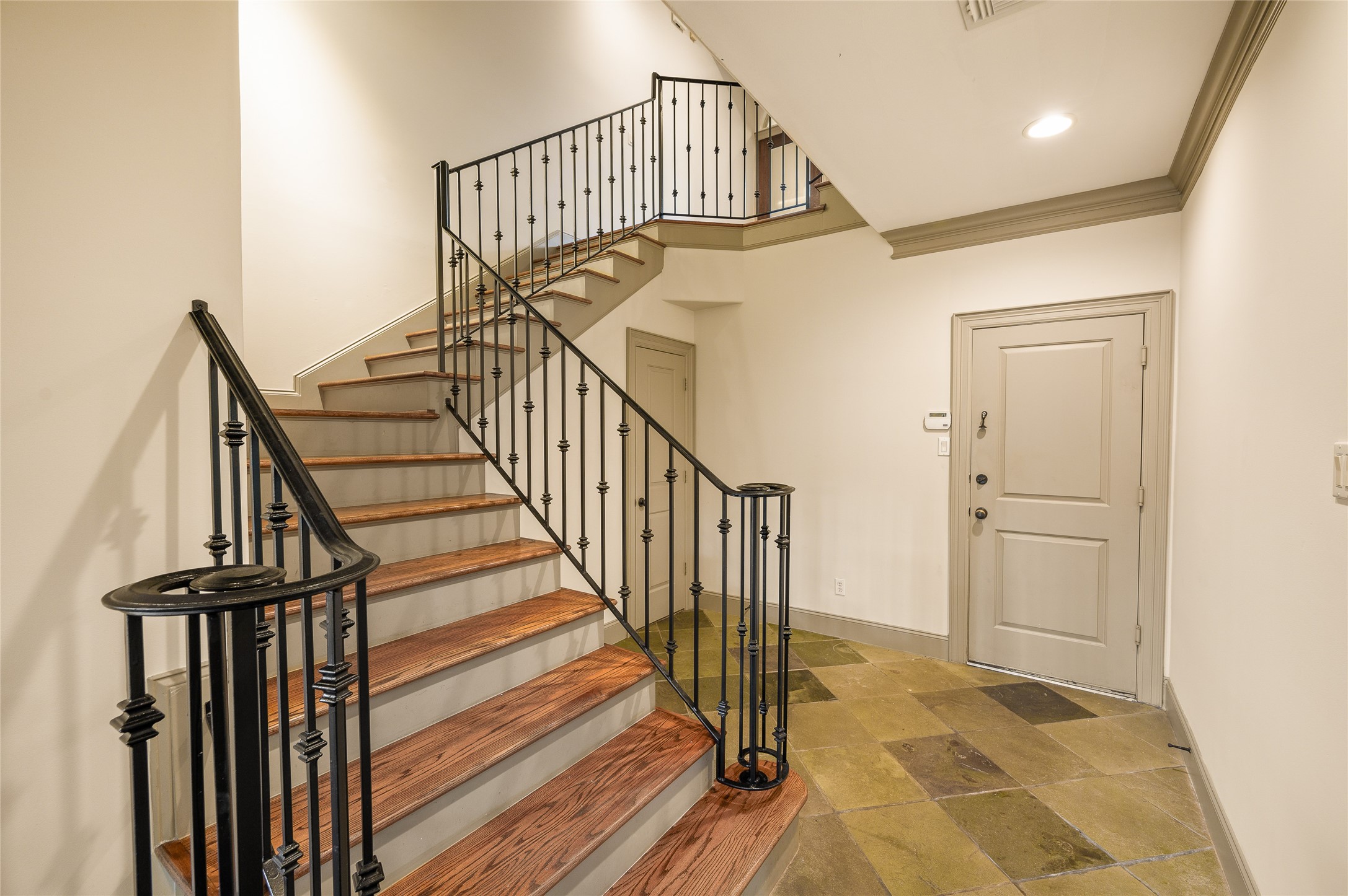 1655 Castle Court Houston, TX 77006 - Photo 14 of 32 Convenient garage entry with bonus storage under the stairs.