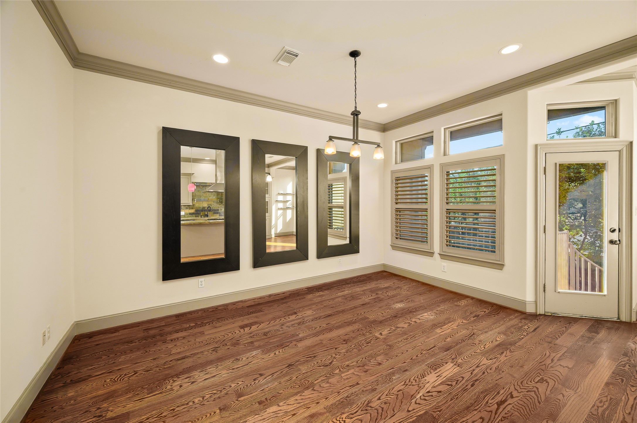 1655 Castle Court Houston, TX 77006 - Photo 17 of 32 This could be a family room or an eat-in kitchen featuring stylish mirrors and convenient patio access.