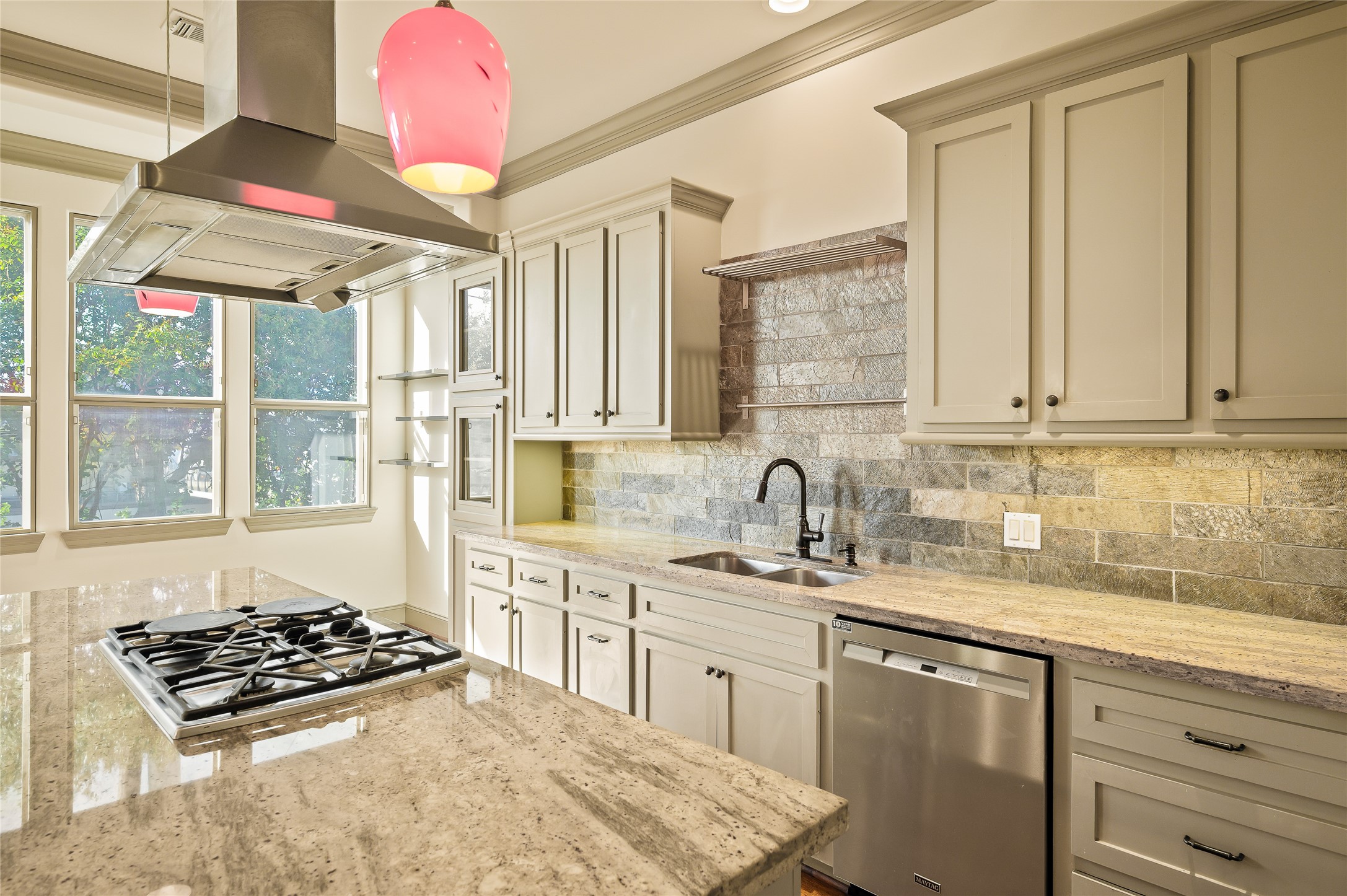 1655 Castle Court Houston, TX 77006 - Photo 19 of 32 Elegant kitchen featuring stainless steel appliances, stone backsplash, granite countertops, a gas cooktop, and a convection oven.