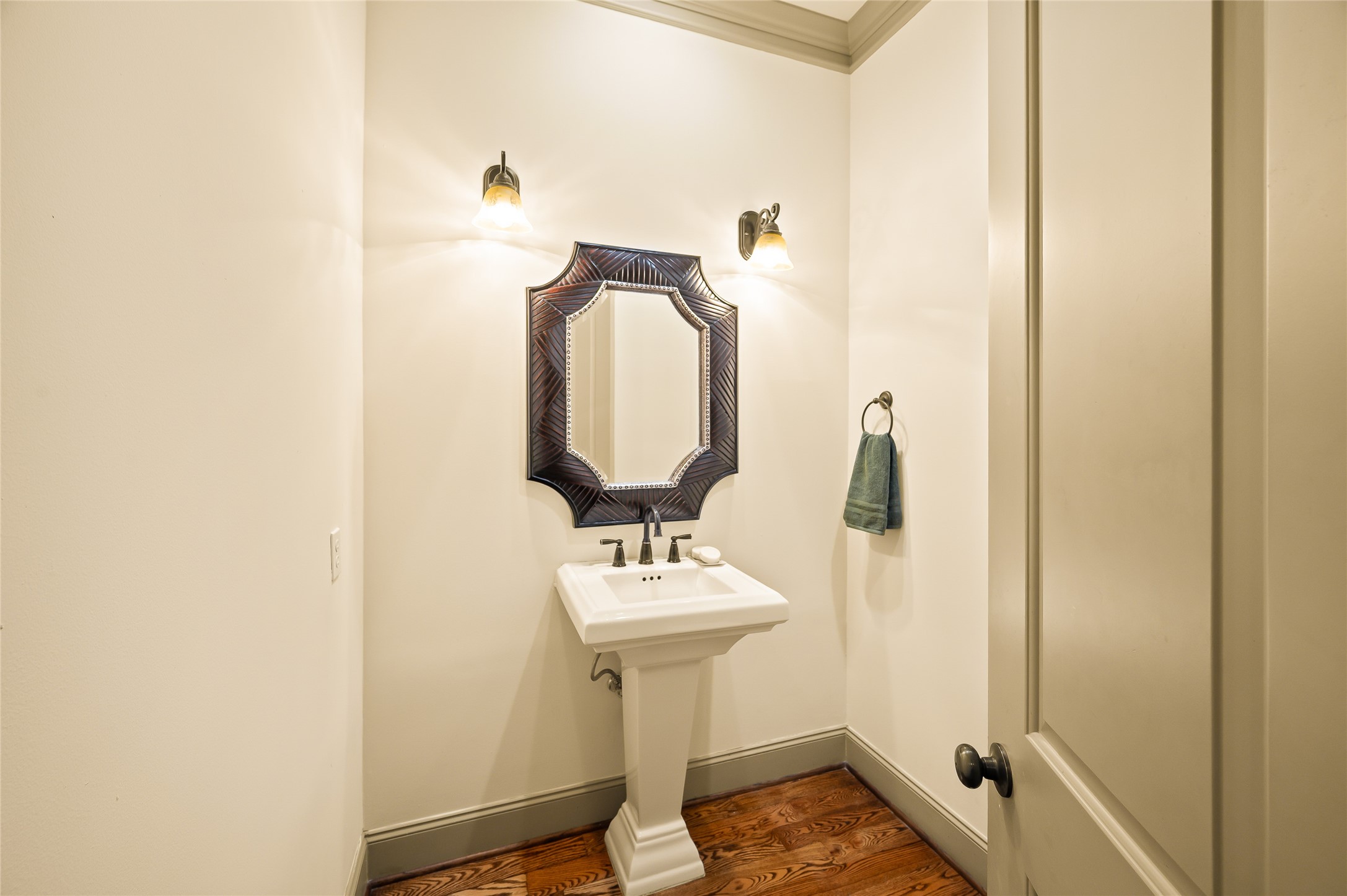 1655 Castle Court Houston, TX 77006 - Photo 20 of 32 Of course there is a powder room on the 2nd floor. Tucked in between the dining room and kitchen. Stylish fixtures and warm lighting.