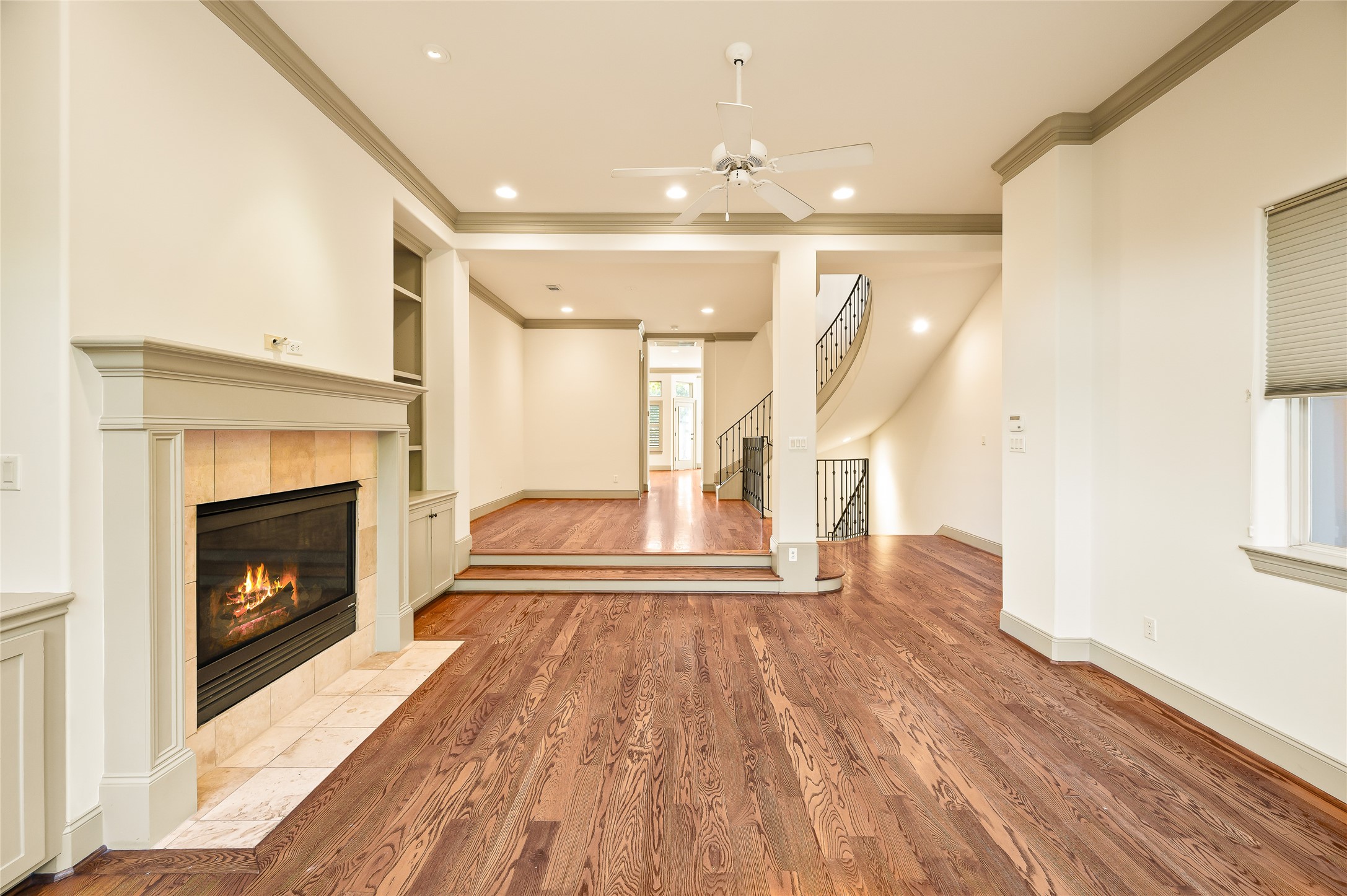 1655 Castle Court Houston, TX 77006 - Photo 2 of 32 Greet your guests on the 2nd floor in this spacious living area. Recessed lighting, crown moulding, wood floors, and a gas log fireplace. The elevation of the dining space defines it.