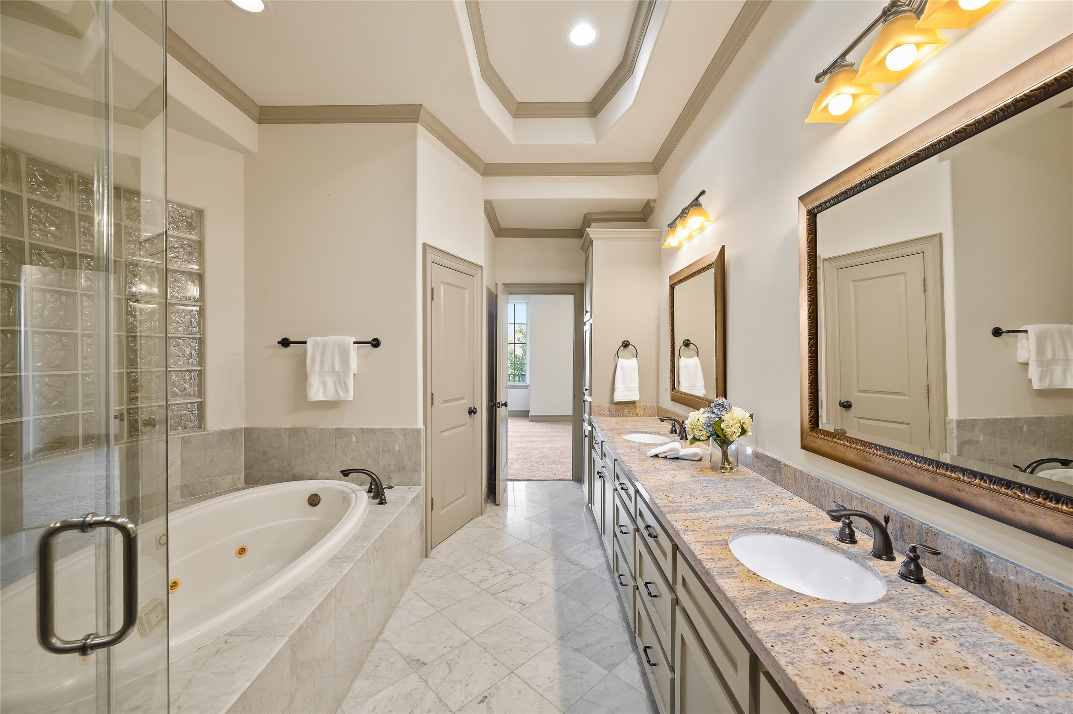 1655 Castle Court Houston, TX 77006 - Photo 27 of 32 The primary bath features a jetted soaking tub, soaring ceilings, double vanity and sinks, a water closet, and abundant storage options.