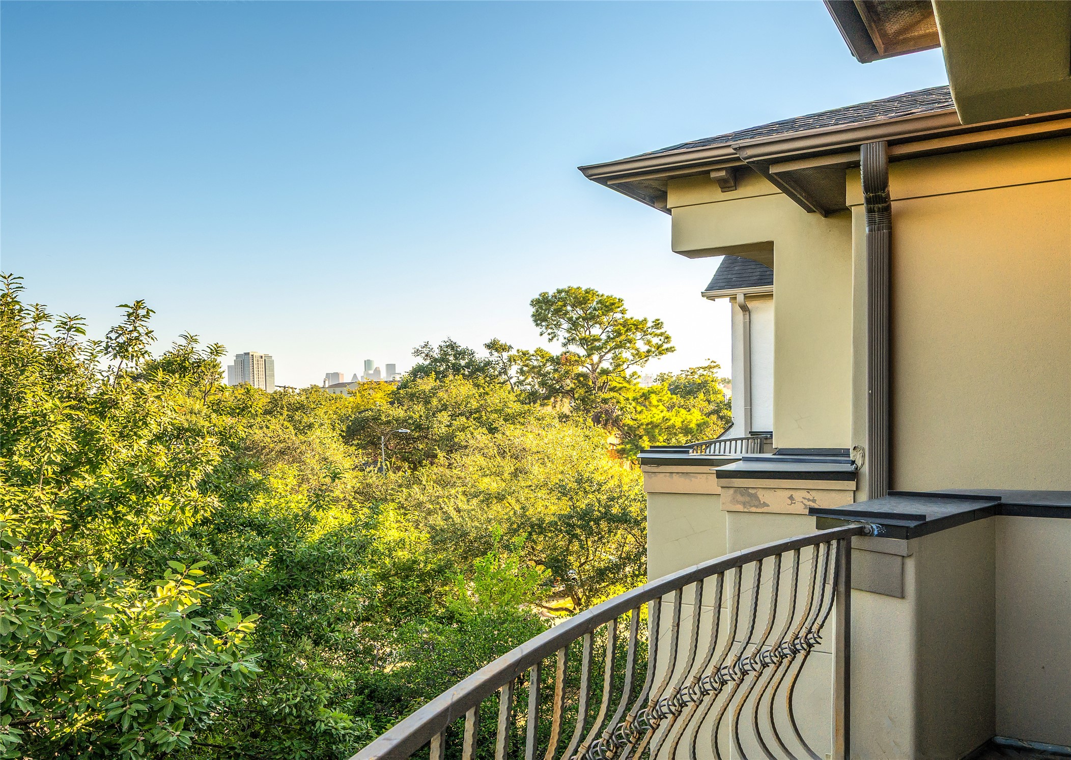 1655 Castle Court Houston, TX 77006 - Photo 6 of 32 A view from the primary terrace, showcasing lush greenery and skyline glimpses.