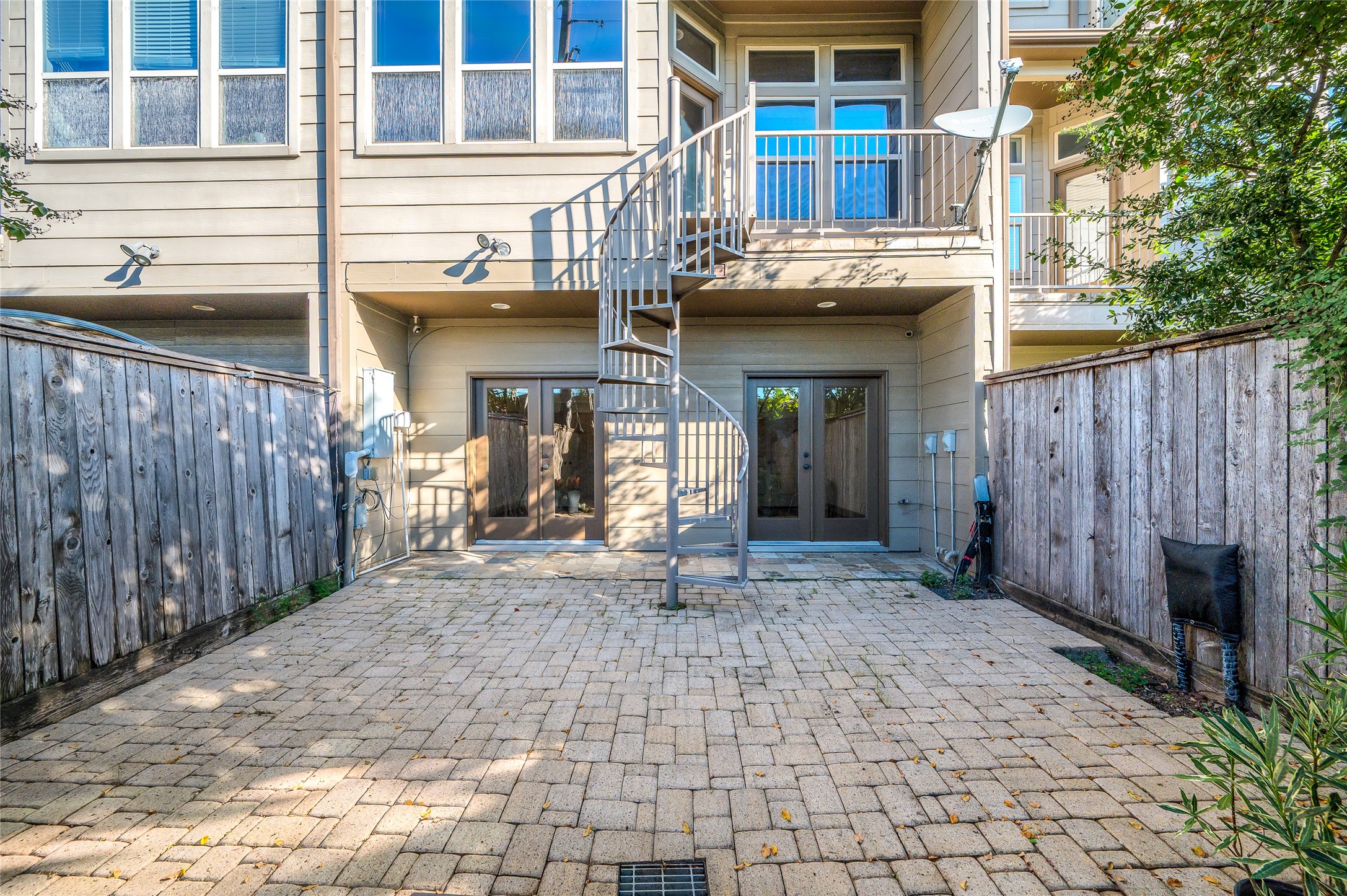 1655 Castle Court Houston, TX 77006 - Photo 9 of 32 A view of the back yard with a covered area just outside the French doors. The spiral staircase leads to a balcony off the kitchen.