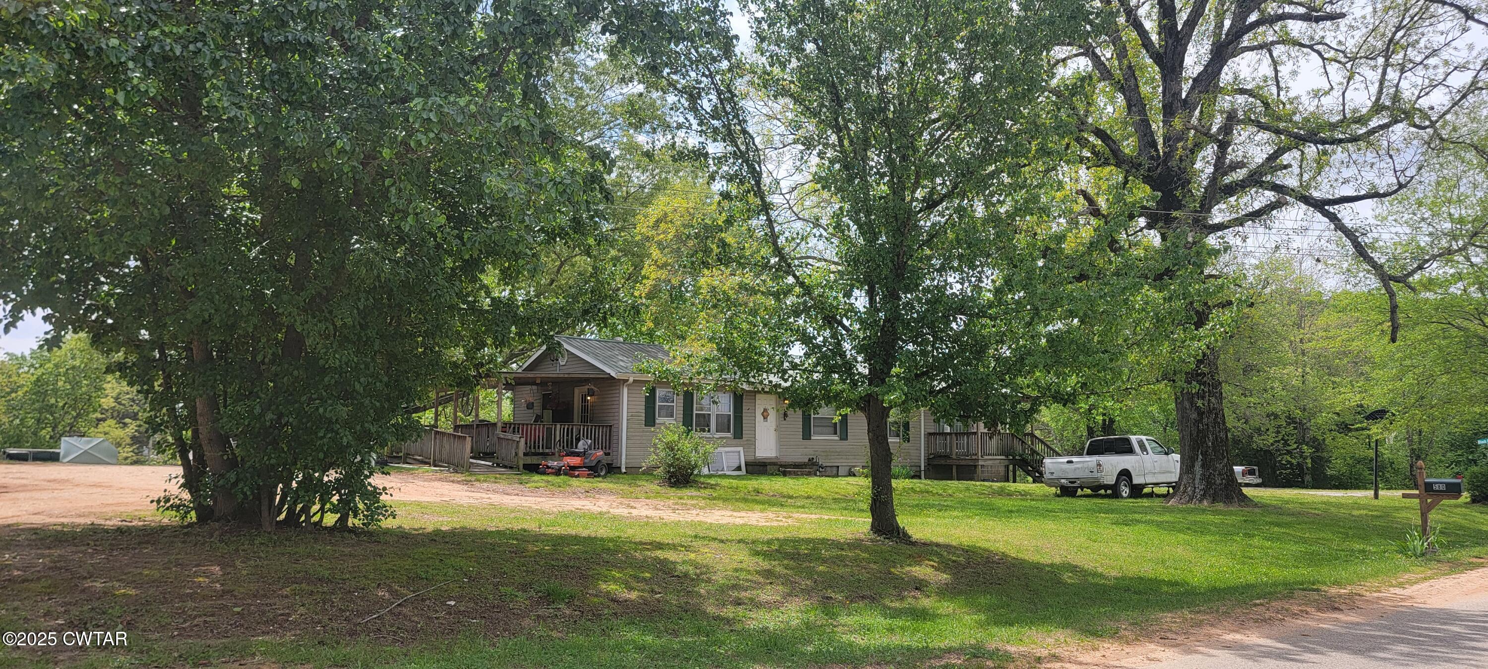 620 Hamilton Road Lexington, TN 38351 - Photo 2 of 7 a front view of a house with a yard and trees