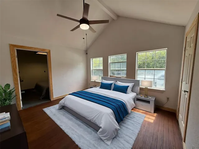 a bedroom with a large bed and a window