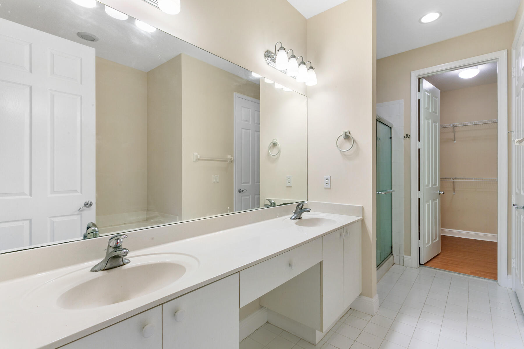 802 University Boulevard Jupiter, FL 33458 - Photo 13 of 16 a bathroom with a double vanity sink mirror and shower