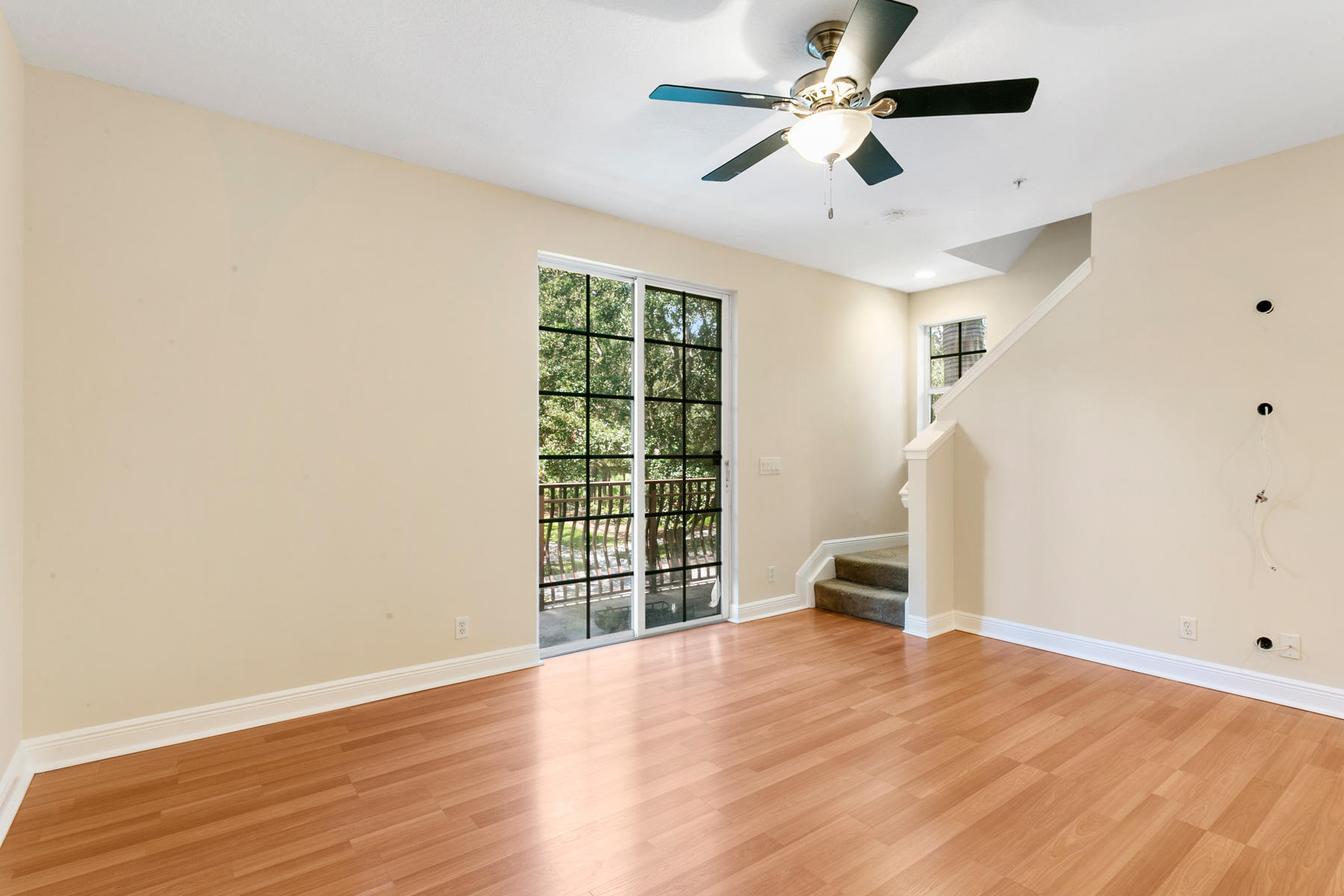 802 University Boulevard Jupiter, FL 33458 - Photo 4 of 16 a view of empty room with wooden floor and fan