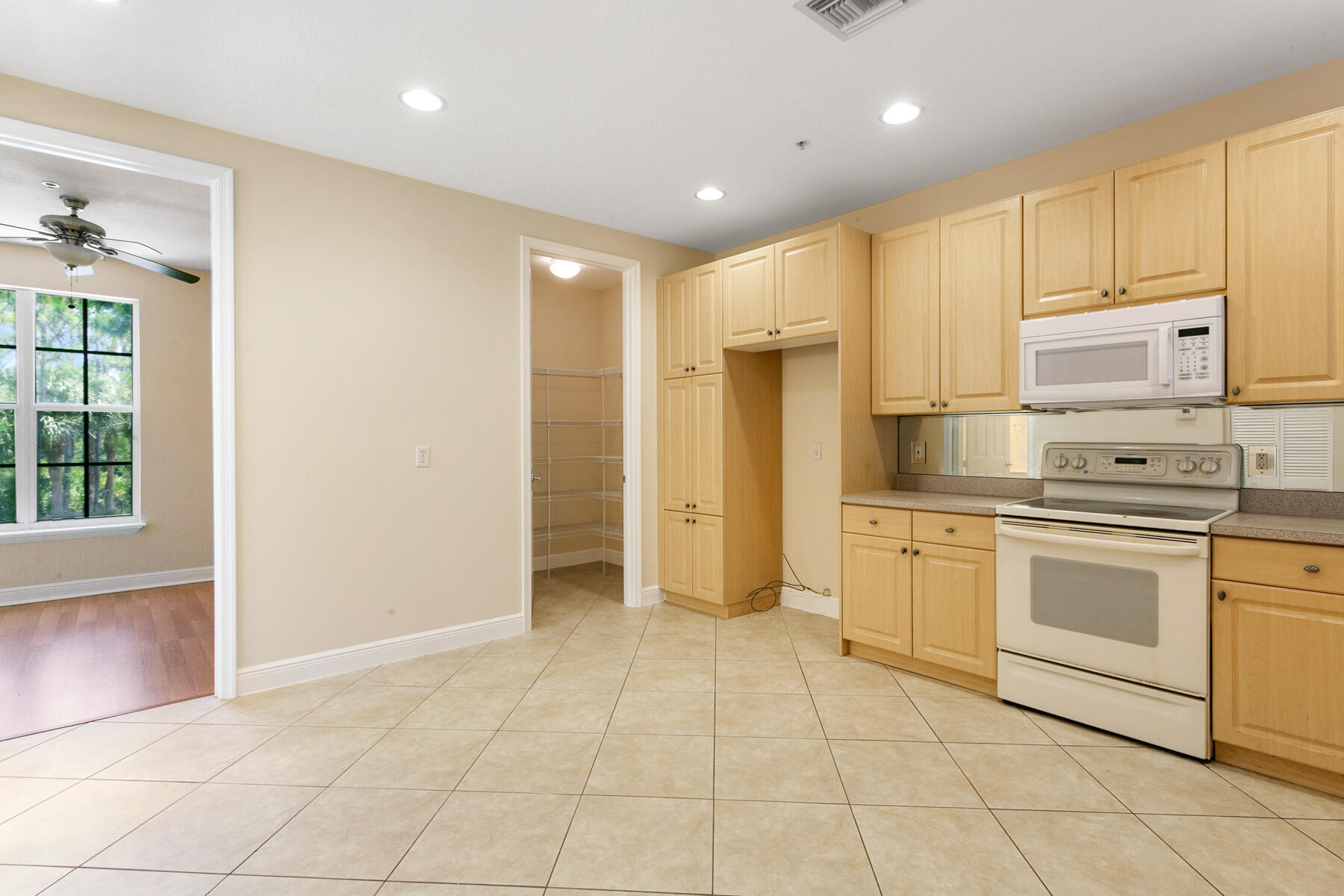 802 University Boulevard Jupiter, FL 33458 - Photo 6 of 16 a kitchen with stainless steel appliances granite countertop a refrigerator and a stove top oven