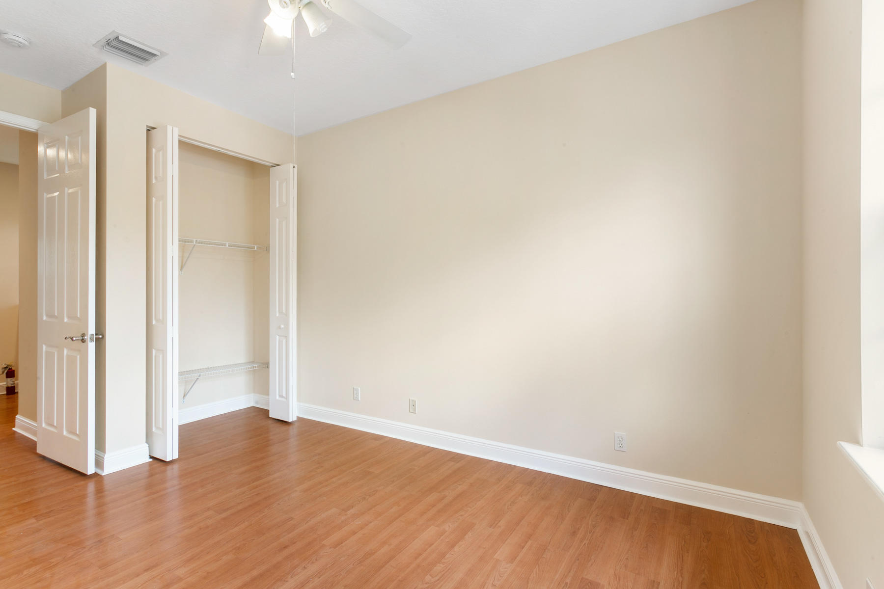 802 University Boulevard Jupiter, FL 33458 - Photo 8 of 16 a view of an empty room with wooden floor