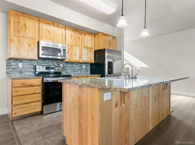 a open kitchen with cabinets a stove and a wooden floors