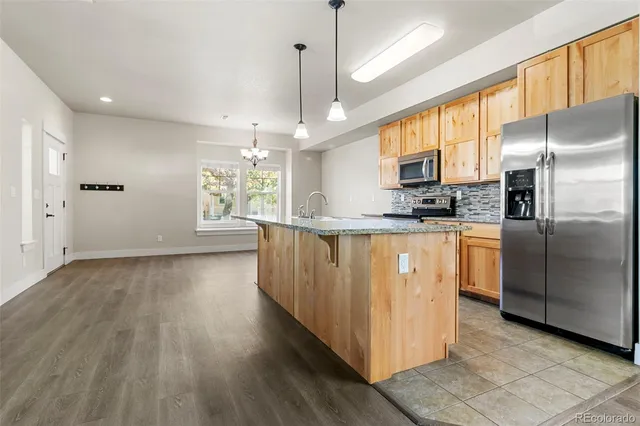 a utility room with closet dryer and window