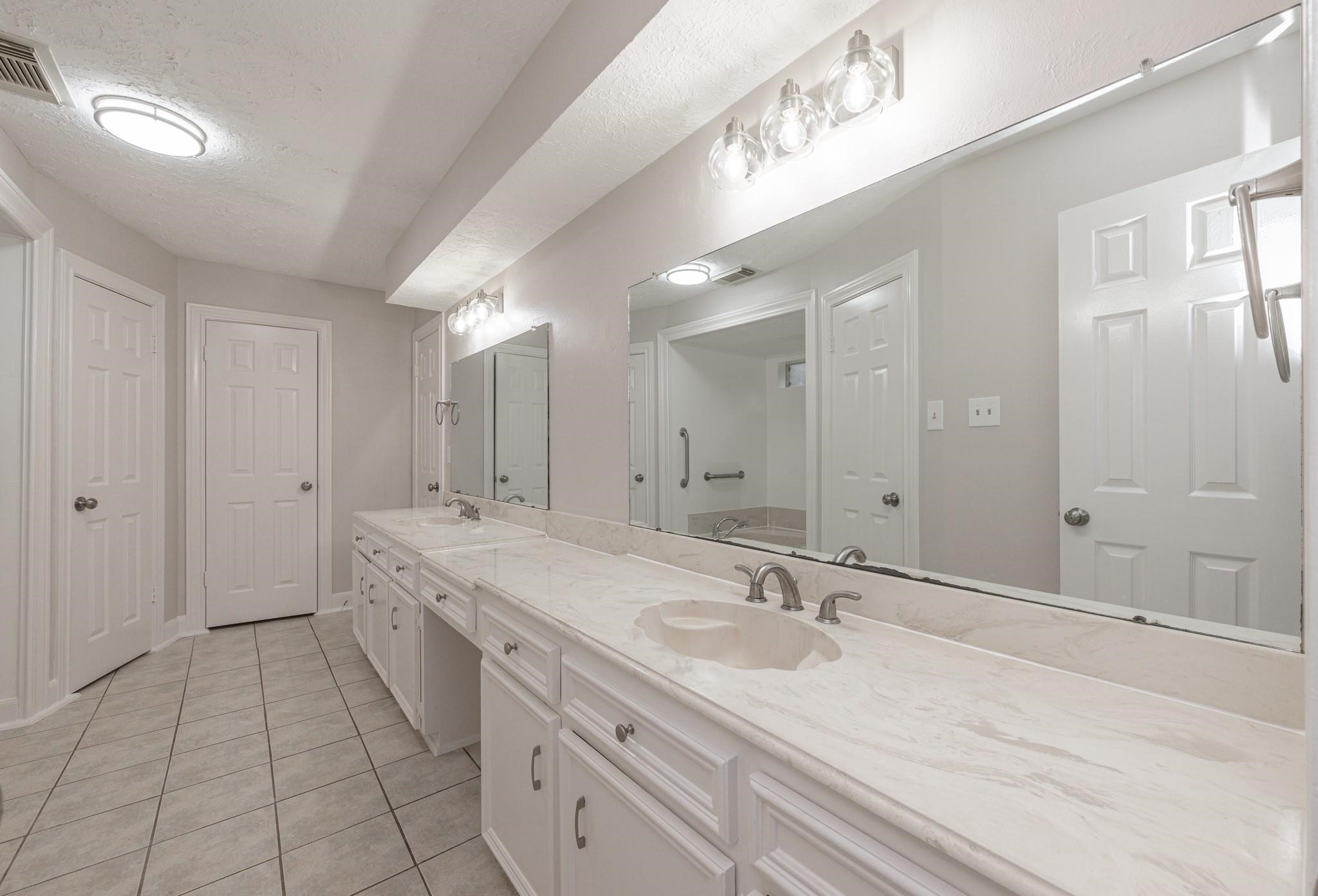 8019 Beaufort Drive Spring, TX 77379 - Photo 33 of 47 a bathroom with a sink and a mirror