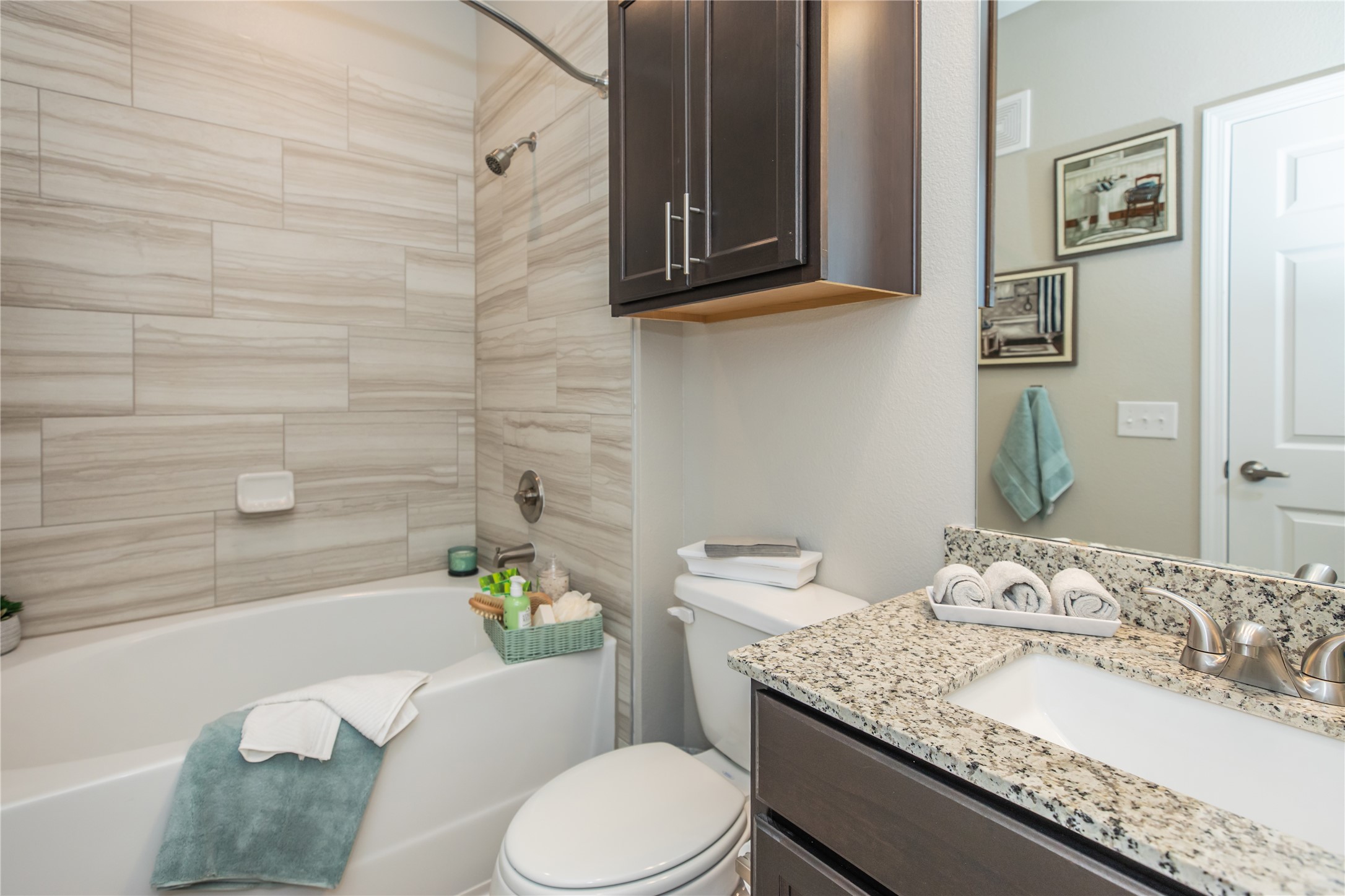 14809 Ralston Road, Unit A18302 Humble, TX 77396 - Photo 12 of 16 a bathroom with a granite countertop toilet sink and mirror