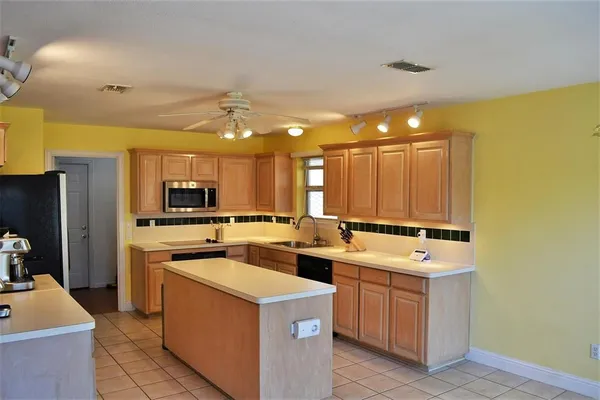 a kitchen that has a sink and a stove in it