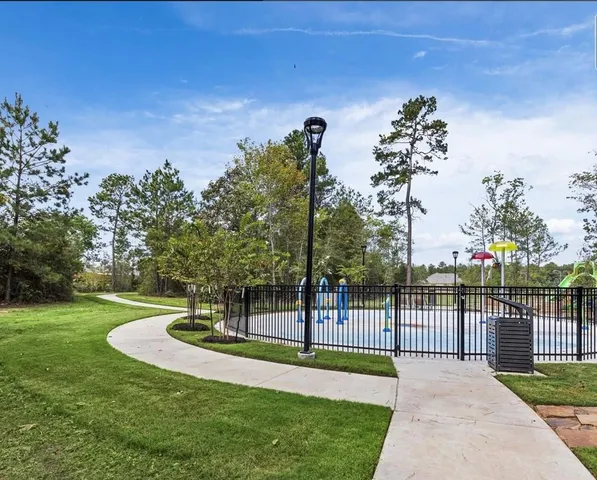 a view of a swimming pool with outdoor seating