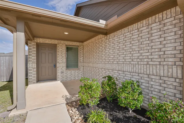 a large white kitchen with stainless steel appliances