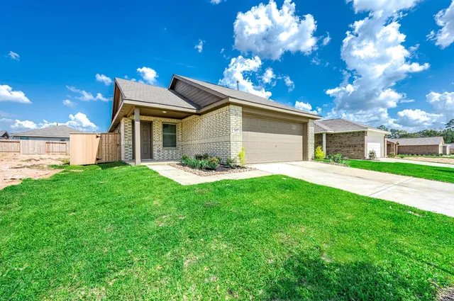 a front view of house with yard and green space