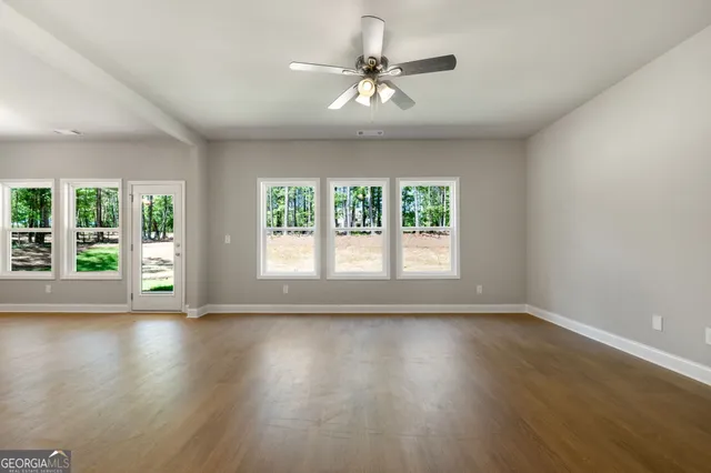 a living room with furniture potted plant and a large window