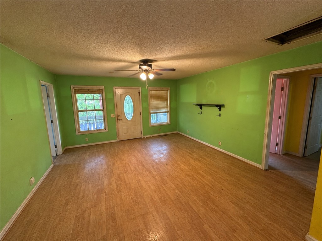 138 Cloverdale Road Seneca, SC 29678 - Photo 10 of 27 A spacious room offers durable flooring and ample natural light, ideal for versatile living.