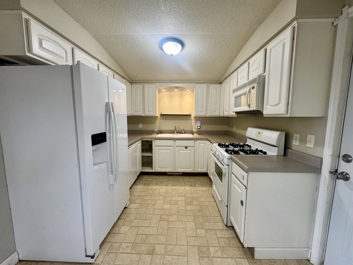 202 North Washington Street Joy, IL 61260 - Photo 6 of 12 a kitchen with stainless steel appliances a stove a sink and a refrigerator