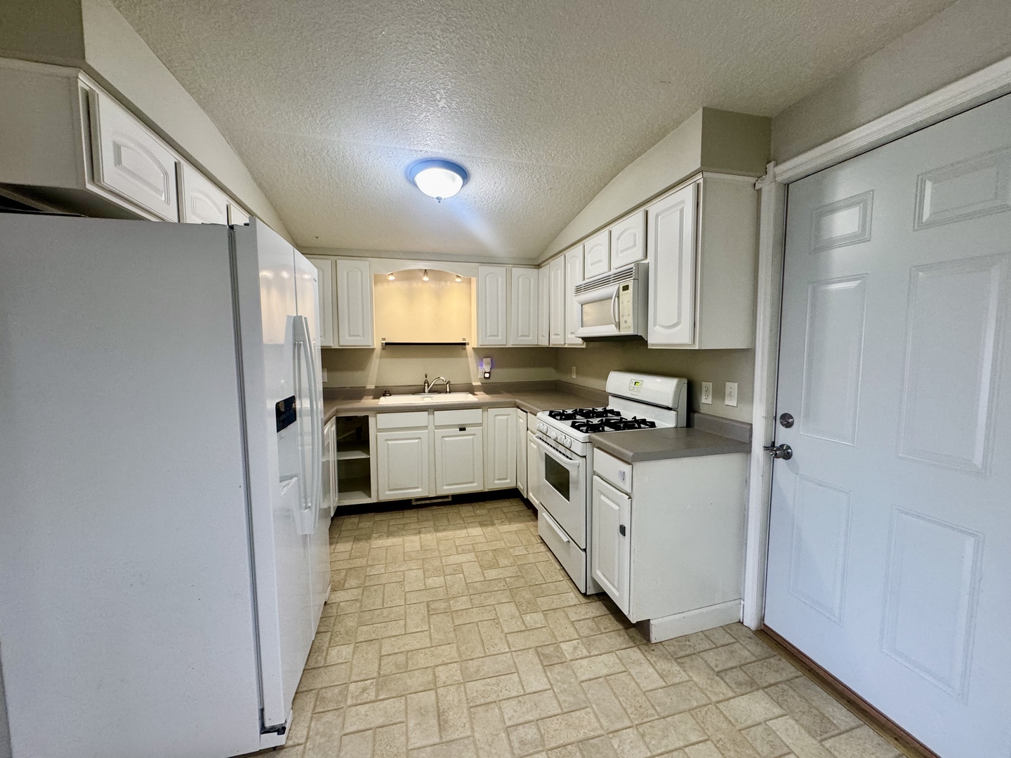 202 North Washington Street Joy, IL 61260 - Photo 7 of 12 a kitchen with a stove sink and a refrigerator