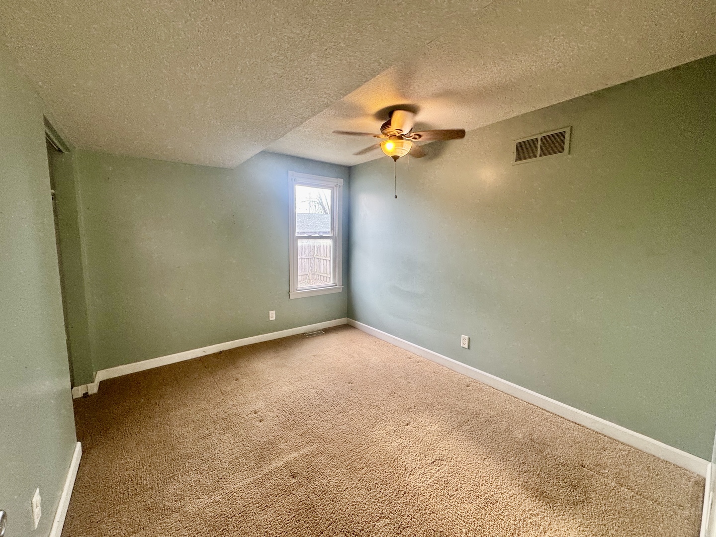202 North Washington Street Joy, IL 61260 - Photo 8 of 12 an empty room with a window