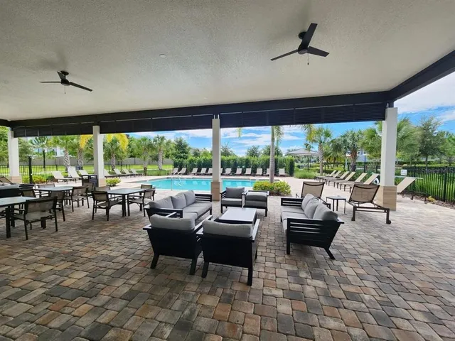 a living room with patio furniture and a large window