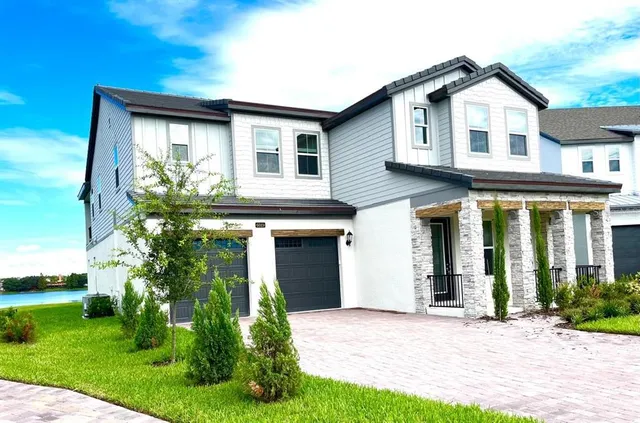 a front view of a house with a garden and plants