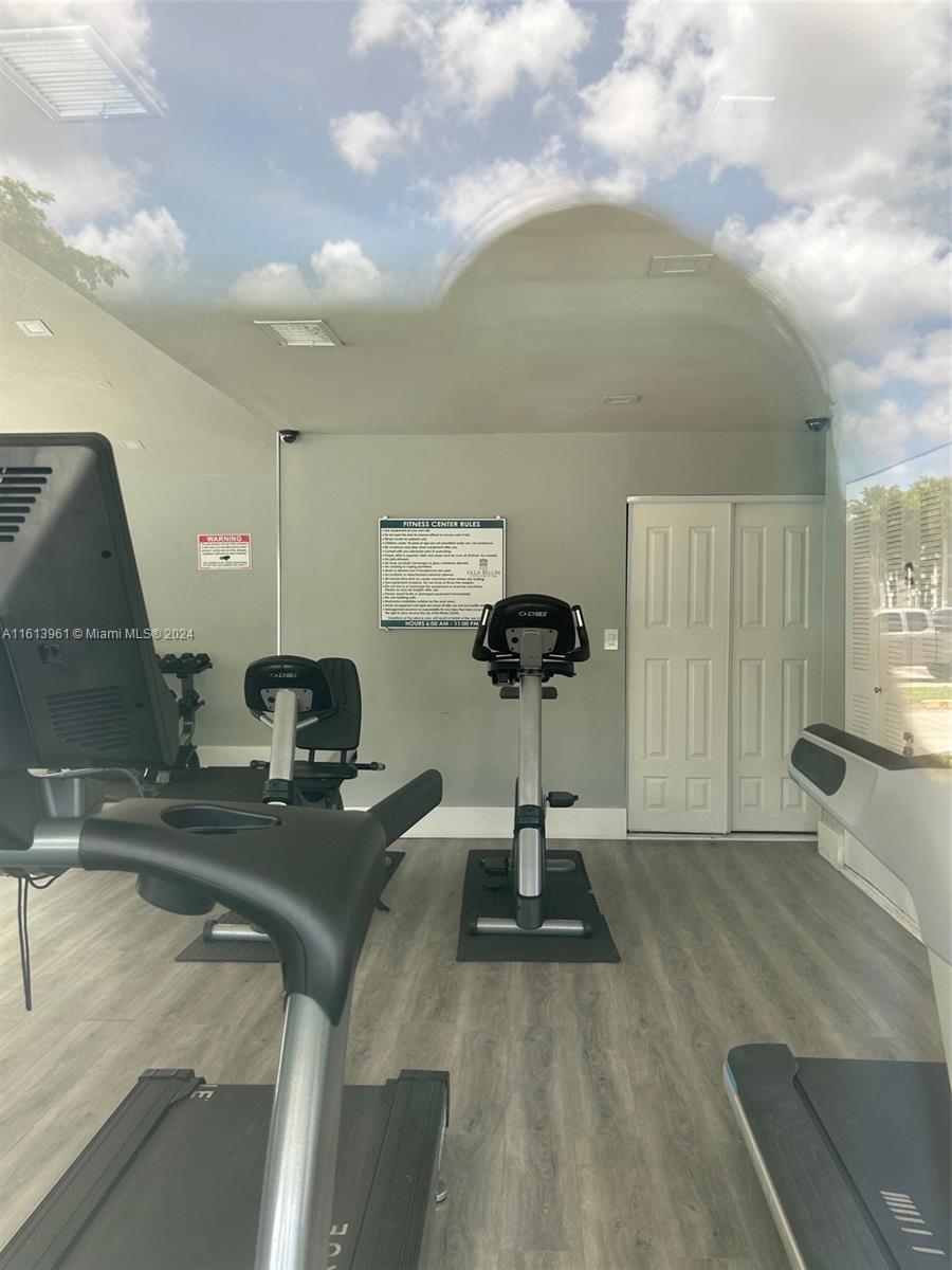 7130 Northwest 179th Street, Unit 303 Hialeah, FL 33015 - Photo 19 of 20 a view of a room with gym equipment