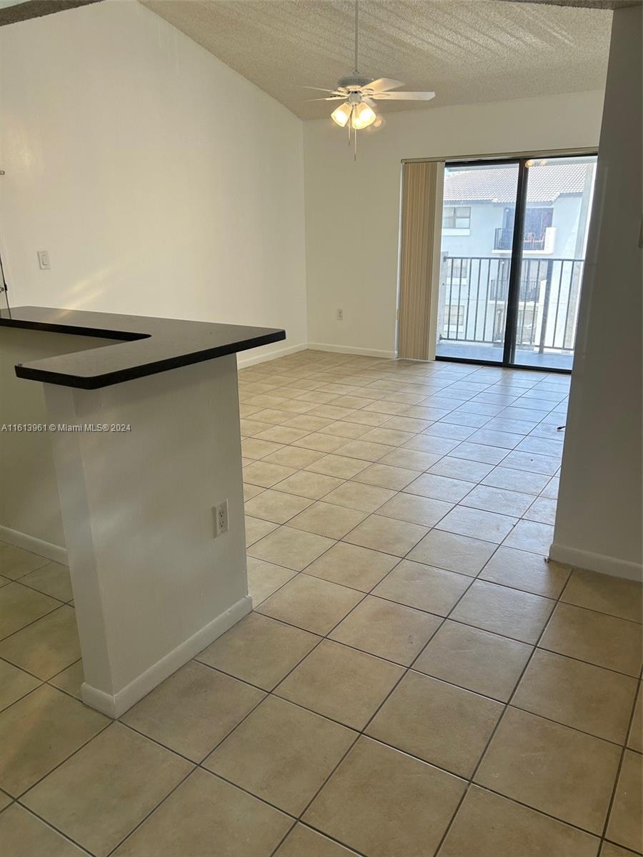 7130 Northwest 179th Street, Unit 303 Hialeah, FL 33015 - Photo 5 of 20 a view of an empty room and window