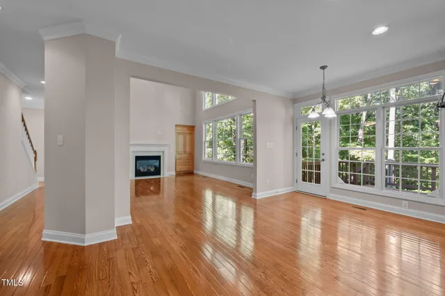 a spacious bedroom with a bed and large windows