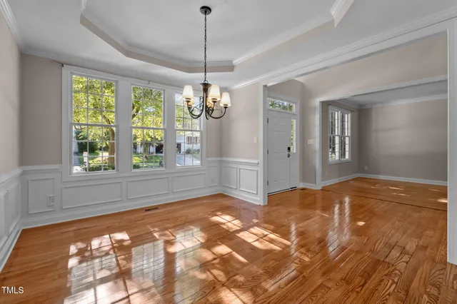 a view of empty room with wooden floor and fireplace