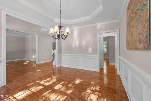 a view of empty room with wooden floor and fireplace