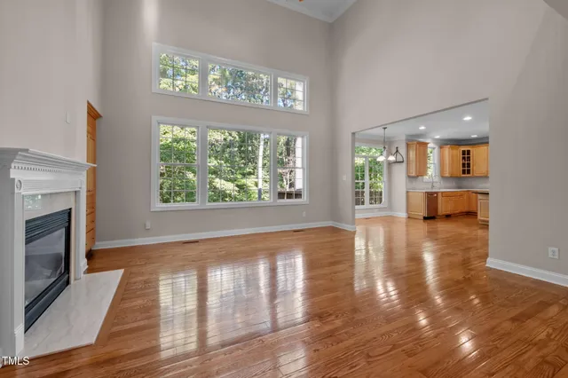a kitchen with a refrigerator a sink and wooden floor