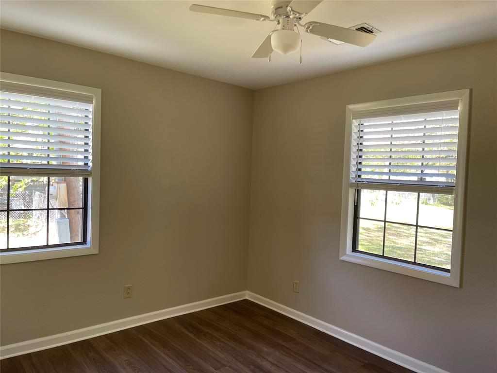1509 Mitchell Drive Bonham, TX 75418 - Photo 6 of 9 a view of a room with wooden floor and windows