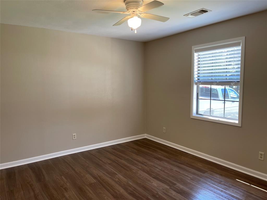 1509 Mitchell Drive Bonham, TX 75418 - Photo 7 of 9 wooden floor in an empty room with a window