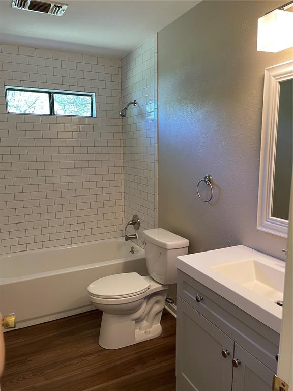 1509 Mitchell Drive Bonham, TX 75418 - Photo 8 of 9 a bathroom with a toilet a sink and bathtub