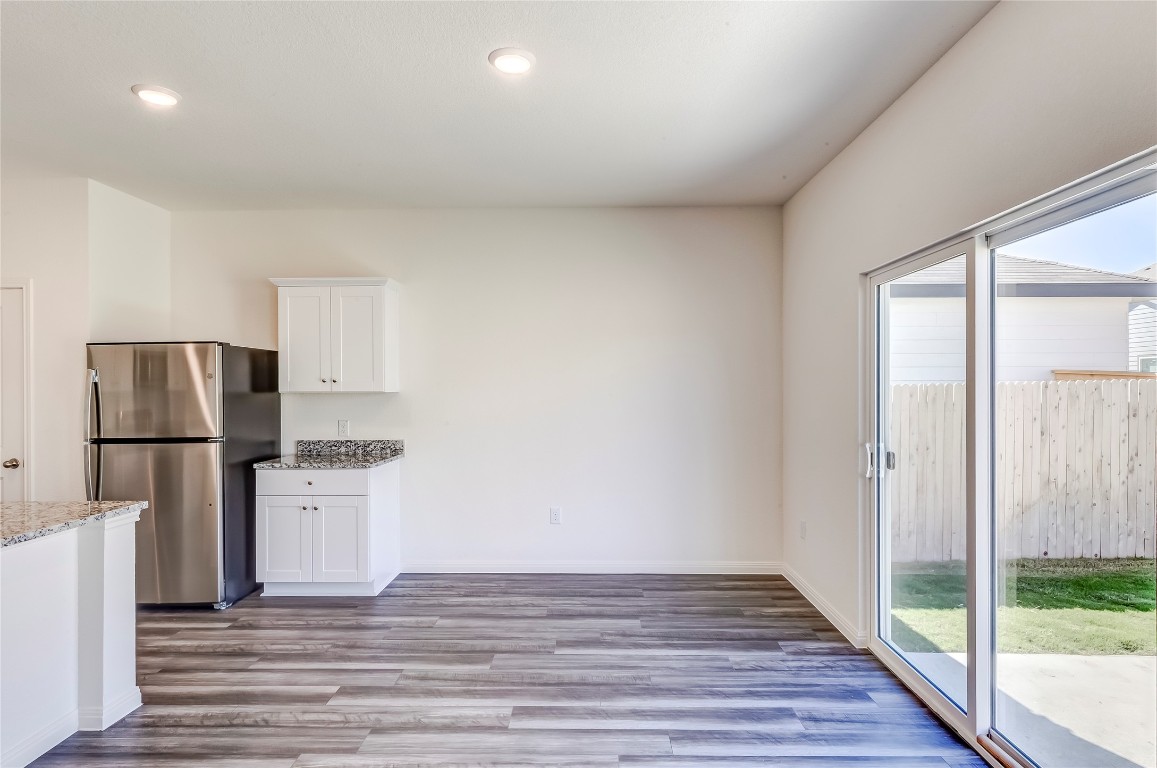 344 Enforcer Loop Jarrell, TX 76537 - Photo 16 of 34 a view of a kitchen with a sink refrigerator and wooden floor