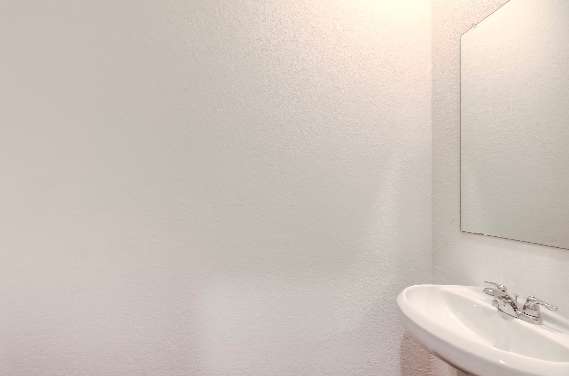 344 Enforcer Loop Jarrell, TX 76537 - Photo 17 of 34 a bathroom with a sink and a mirror