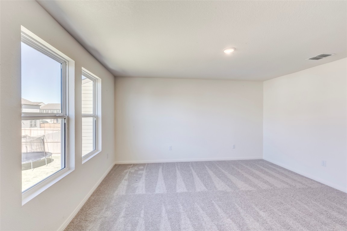 344 Enforcer Loop Jarrell, TX 76537 - Photo 23 of 34 wooden floor in an empty room with a window