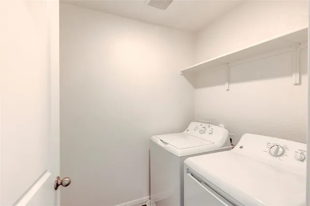 a view of a house with a yard and wooden fence