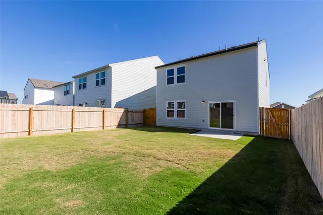 a view of a house with a backyard